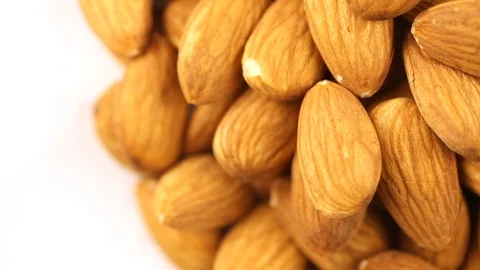 Almonds spinning on the surface. Overhead view. Colors out of camera. Stock Footage 94142995