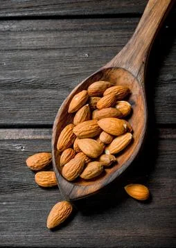 The almonds in the spoon . Stock Photos