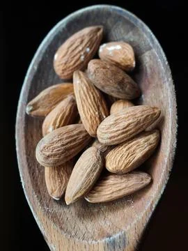Almonds on a spoon Stock Photos