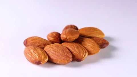 Almonds on white background, rotating Stock Footage 312975416