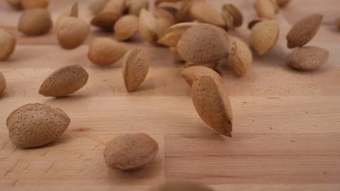 Almonds on wood background, slow motion Vídeos de archivo 87710094