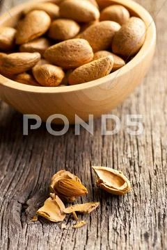 Almonds in wooden bowl Stock Photos