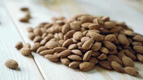 Almonds on a wooden table. Close-up texture of almonds Stock Footage 118222679