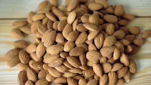 Almonds on a wooden table. Close-up texture of almonds. Top view. Stock Footage 118222972