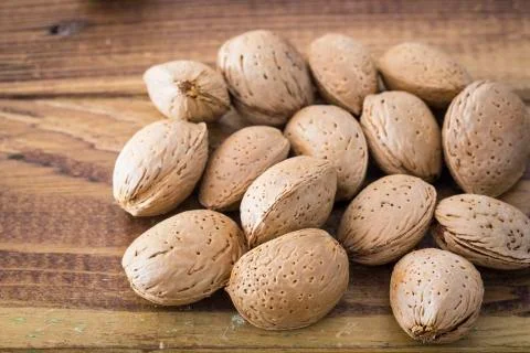 Almonds on a wooden table Foto stock