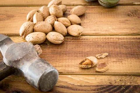 Almonds on a wooden table Stock Photos