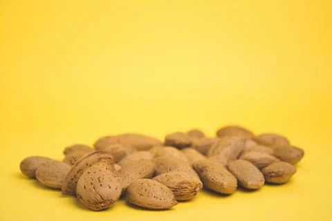 Almonds on a yellow background Foto stock