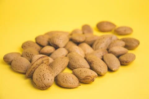 Almonds on a yellow background Stock Photos