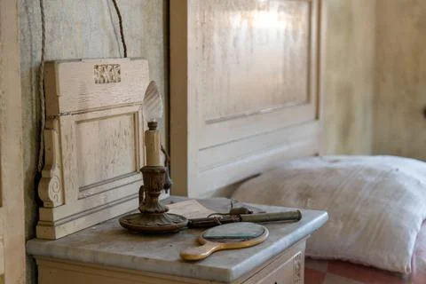 Almost burnt candle on a bedside table in a bedroom, in an abandoned house. urbe Stock Photos