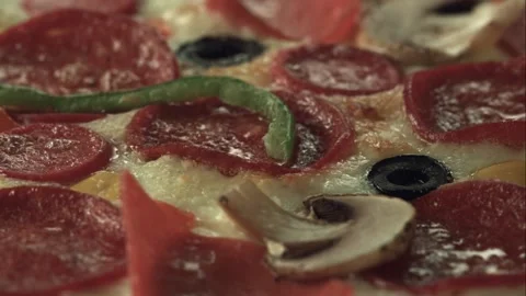 An almost cooked pizza is cooking while it's rotating in the oven. Close up. Stock Footage 161526263