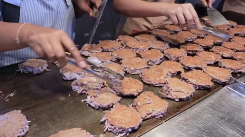 Almost done for serving, delectable Kanom Babin Thai Coconut Dessert on Pan Stock Footage 331773991
