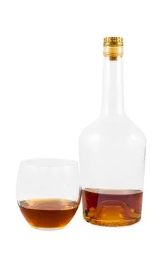 Almost empty bottle and glass of whiskey Stock Photos