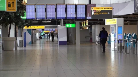 Almost empty Schiphol airport departure terminal during coronavirus crisis Stock Footage