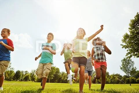 Photograph Almost at the finish line. a group of diverse and happy kids playing together 239051112