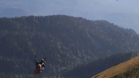 Almost like floating in space, a paraglider moves smoothly through the air Video stock 82110477