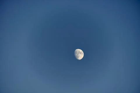 An almost full moon on a blue background Stock Photos
