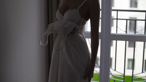 Almost nude girl trying on a dress. Silh... | Stock Video | Pond5