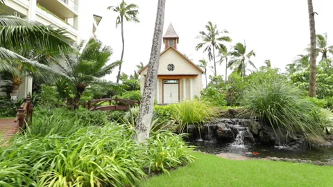 Aloha Films - Small Waterfall Pond With Surrounding Garden With Church - 01  Stock Footage 146341850