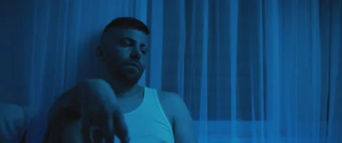 Alone and depressed man apathetically sitting in the bedroom, staring to nowh Stock Footage 147542360