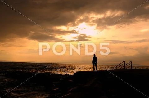Alone on the beach, young Stock Photos