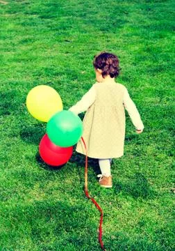 Alone child with balloons Stock Photos