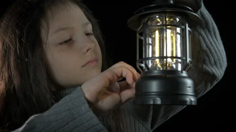 Alone child lighting bulb on black background. Stock Footage 308574954