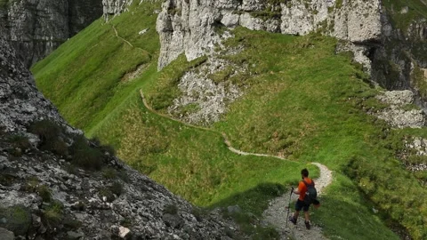 Alone hiker with a backpack walking on mountain in summer time Stock Footage 158841479