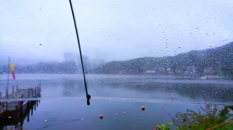 Alone at lake on the rainy day. Clear umbrella and raindrops dripping Stock Footage