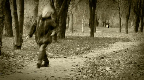 Alone little boy joyful bouncing walking in autumn park 動画素材 33045633
