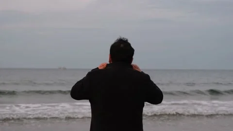Alone man, alone man in overcoat watching the sea with his back turned Stock Footage 168106691