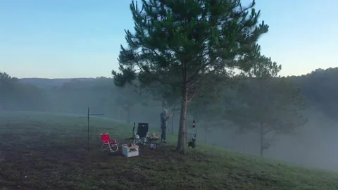 An alone man sitting enjoying a new day, watching the sunrise on the hills Stock-Footage 158201716