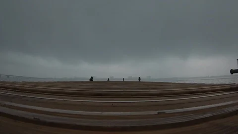 Alone man standing at river pier looking forward thinking and relaxing Stock Footage 106456657