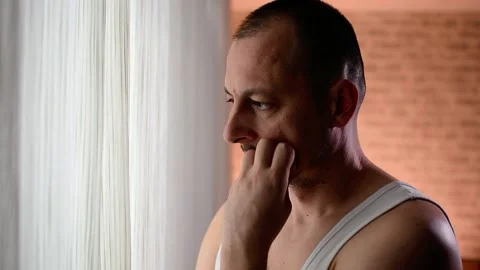 Alone man staring at the window closed with curtains in bedroom. Stock Footage 149514086