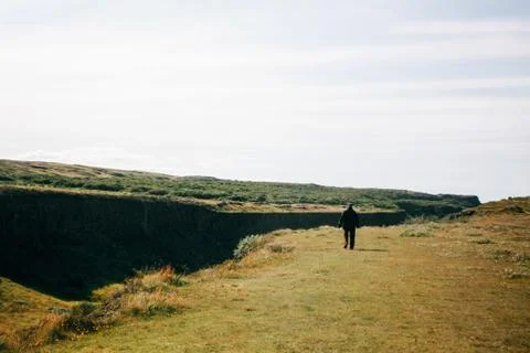 Alone man walking on the Icelandic landscape Stock Photos