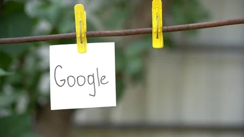 Alone paper with word Google on yellow clothespin hanging on rod near empty pin. Stock Footage 108774888
