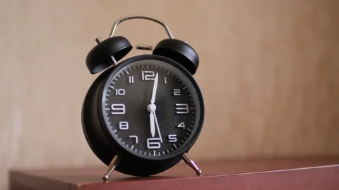 Alone retro alarm clock indoor. A retro clock ringing in the morning on the beds Stock Footage 256154458