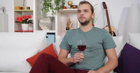 Alone Single Man Relaxing and Drinking Cup of Red Wine Sitting Living Room Sofa Stock Footage 83429769