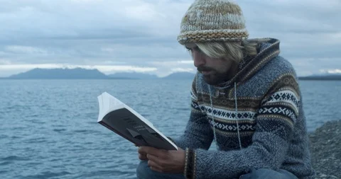 Alone time reading a book at scenic lake Stock Footage 90076283