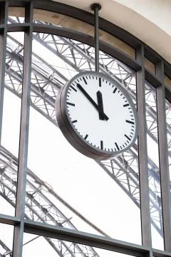 Alone train station's clock hangs on big window Stock Photos