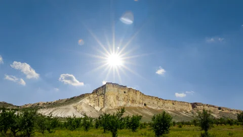 Alone white mount under a sparkle sun time lapse scene Stock Footage 197480531