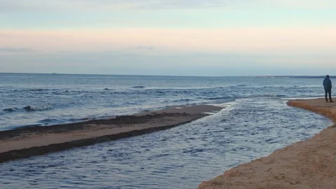 Alone Young Man Looking on Beach in Sunset Video stock 130876506