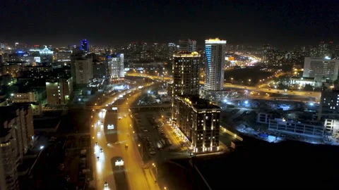Along highway with yellow lights drone goes to cityscape night of metropolis Stock Footage 101054896