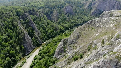 Along the river between the rocks flight. Green mountains. Stock Footage 129509934
