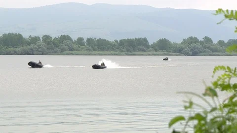 Along the river you go, three Navy inflatable boats Video stock 116036650