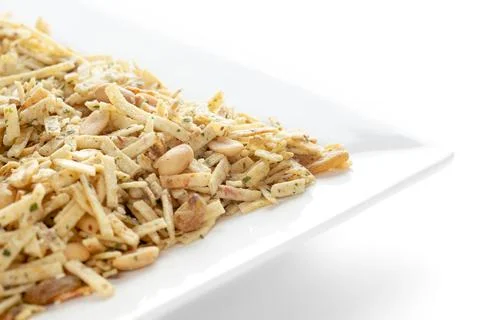 Aloo Mixture in white ceramic square plate made with potatoes peanuts raisins Stock Photos