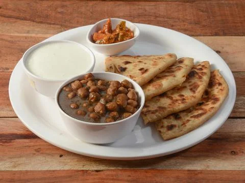 Aloo Paratha or Indian Potato stuffed Flatbread and channa masala Served with Stock Photos