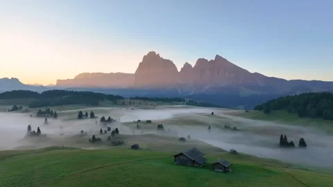 Alpe di Siusi (Backward Drone Shot) 01 | Sunrise | Italian Dolomites | Fog | 4K Stock Footage 259925545