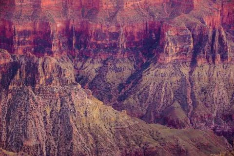 Alpenglow paints the cliffs Stock Photos