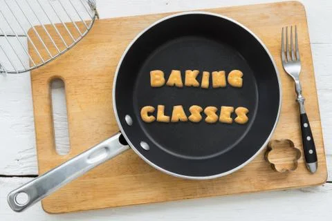 Alphabet biscuits word BAKING CLASSES and kitchenware Stock Photos