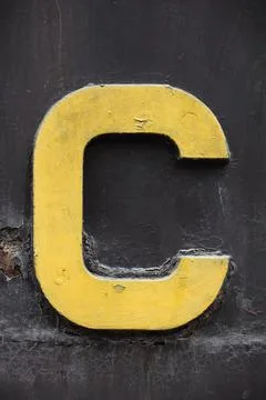 Alphabet C on a rustic metallic sheet. 스톡 사진
